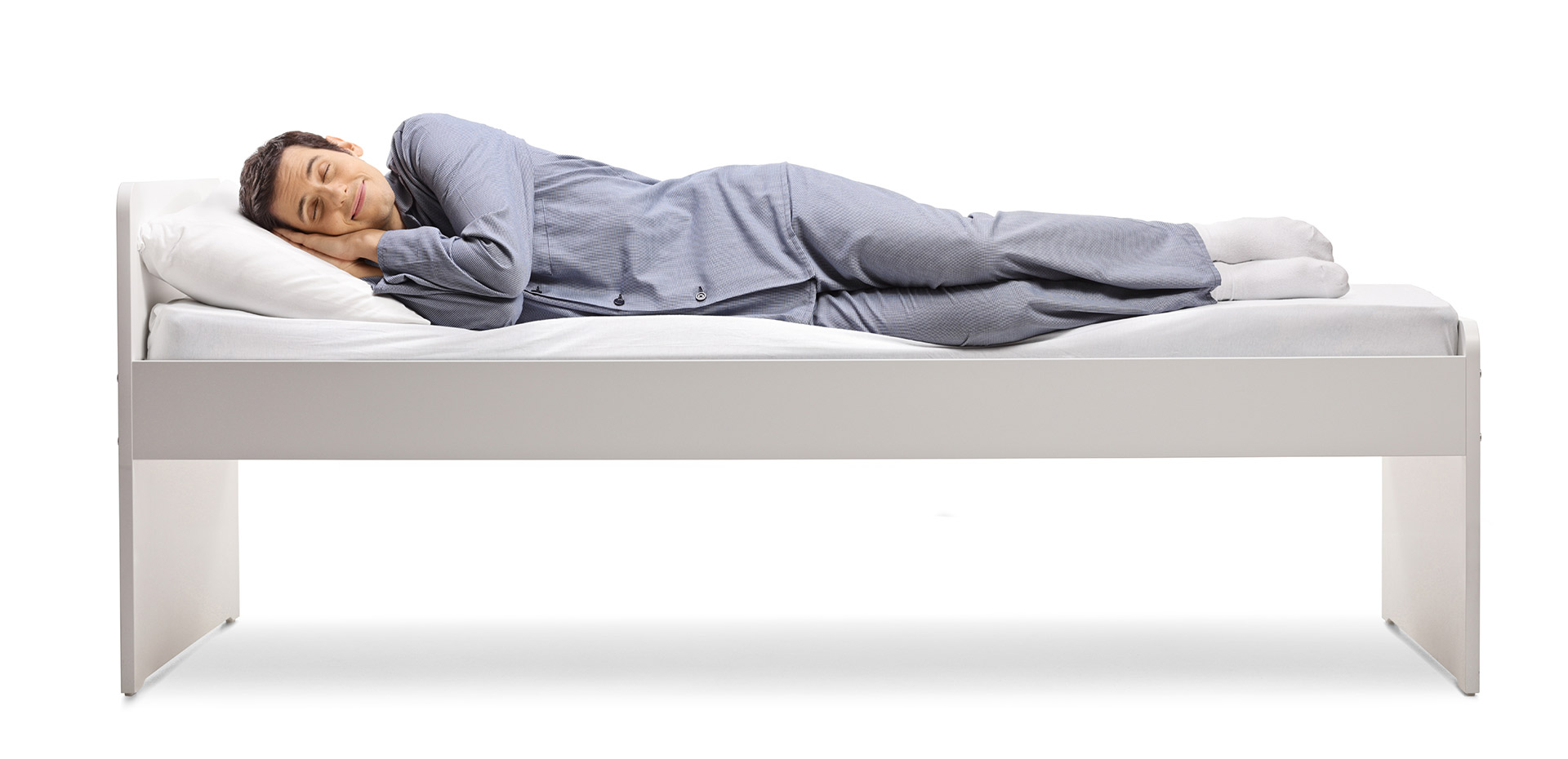 Mann schläft bequem und zufrieden auf seinem Bett.
